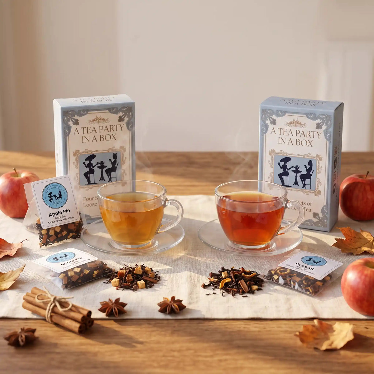 Fall tea gifts: Apple Pie and Fireball loose leaf teas brewed in glass cups with cinnamon sticks and apples