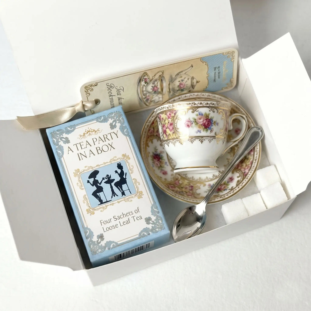 Mini Tea Party Box contents: Box of Tea, Teacup and Saucer, tablespoon, sugar cubes