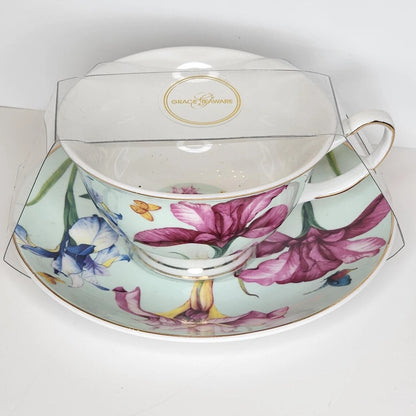 Butterfly Iris teacup and saucer with pink and blue irises and small butterflies on a mint green background, gold-tone rim