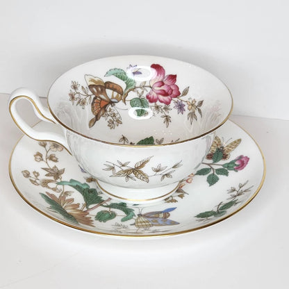 English Floral teacup and saucer with a pink rose, butterflies, moths and green leaves on white, gold-tone rim