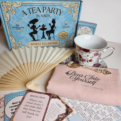 Simple Pleasures tea party gift box with a rose teacup and saucer, paper fan, gold-tone teaspoon, pouch, tea cards and bingo