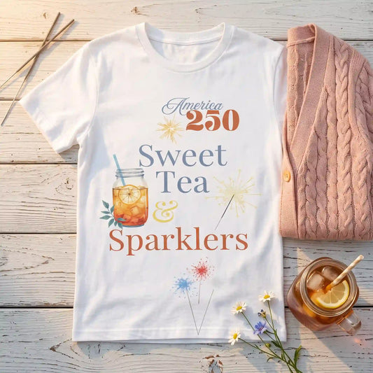 White Sweet Tea & Sparklers America 250 Fourth of July shirt laid flat beside a mason jar of iced tea and sparklers